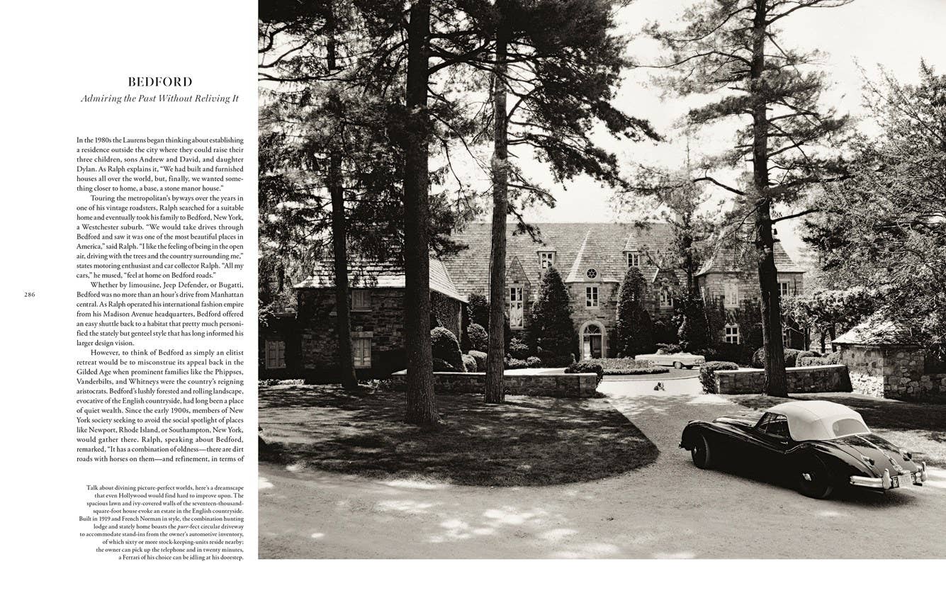 Vintage car parked in a driveway with trees and a building in the background