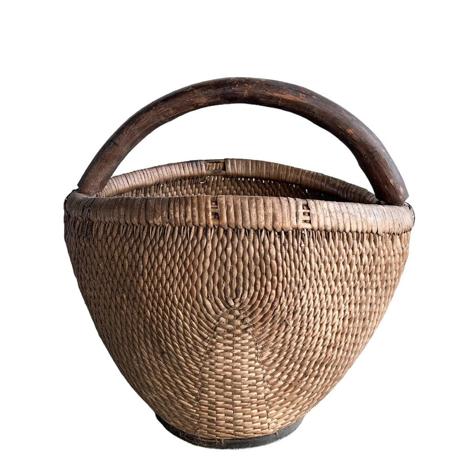 Woven basket with a handle on a white background
