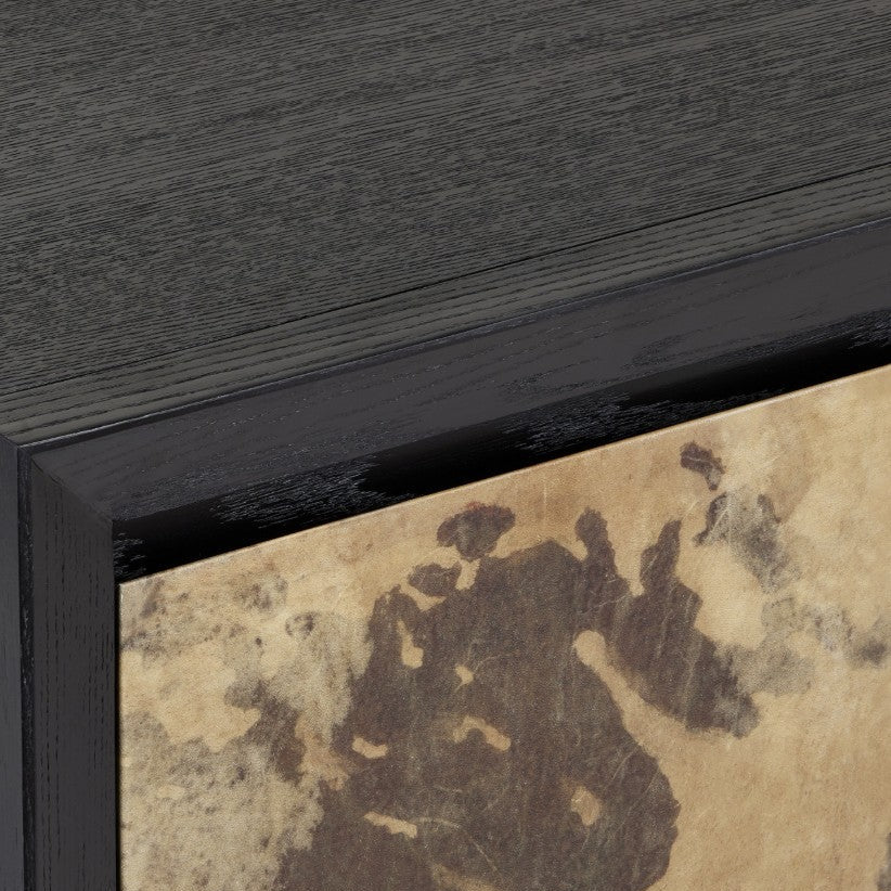 Close-up detail of a framed artwork showing a dark charcoal wood frame and a textured beige and brown abstract panel.