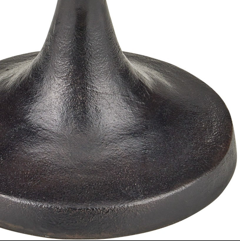 Close-up of a dark cast iron table base with a textured, matte-finished circular foot and a tapered neck rising upward, shown against a plain white background.