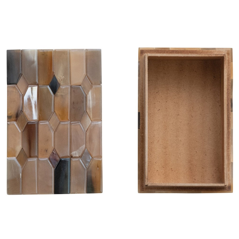 Wooden box with geometric patterned lid on a white background