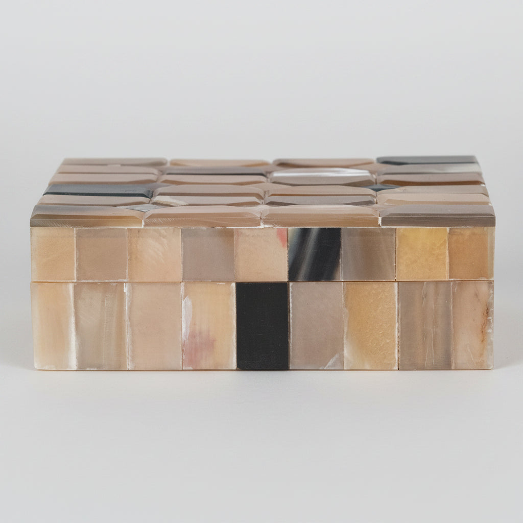 Decorative box with a mosaic pattern of brown and beige stones on a white background