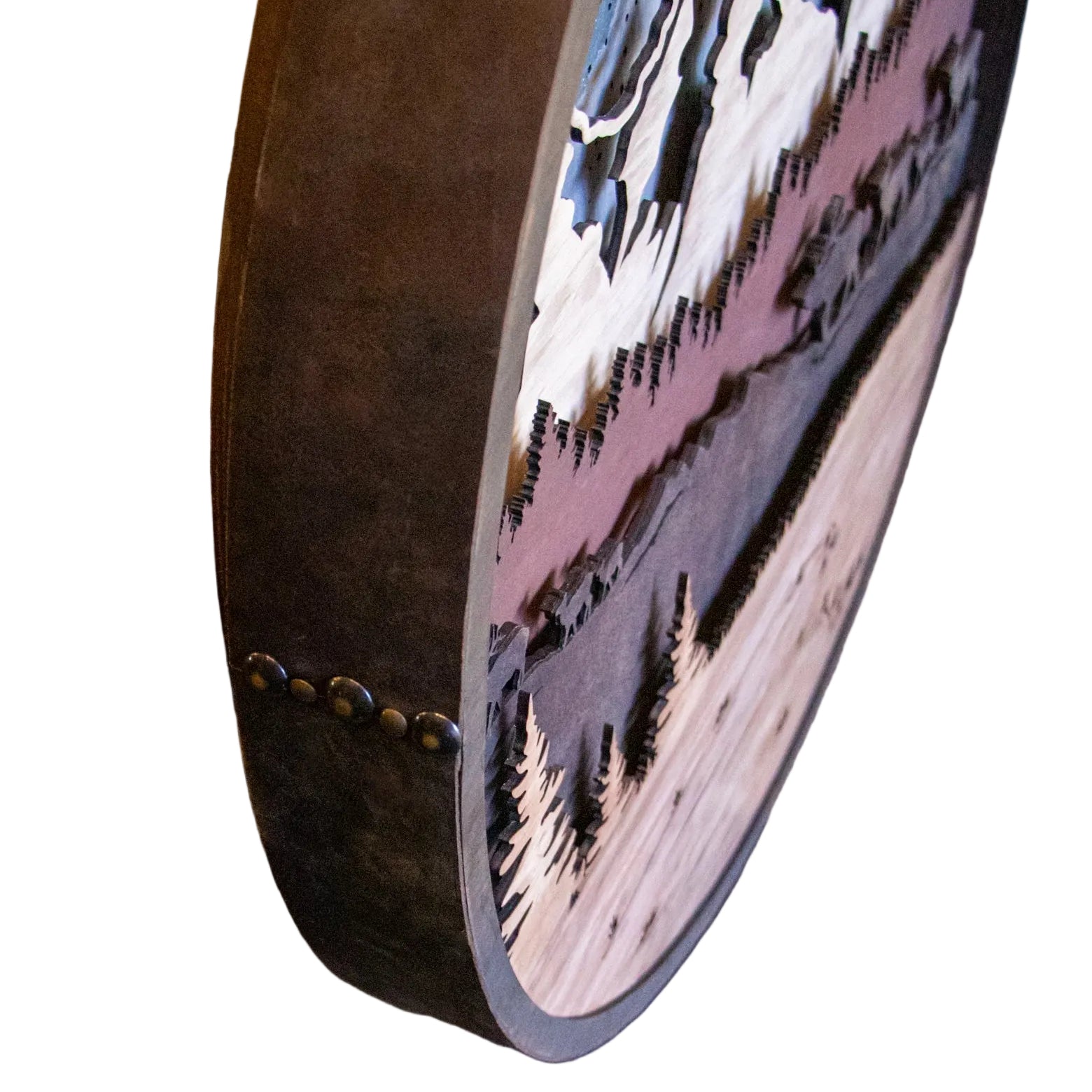 Round wooden coaster with mountain design on a wooden surface
