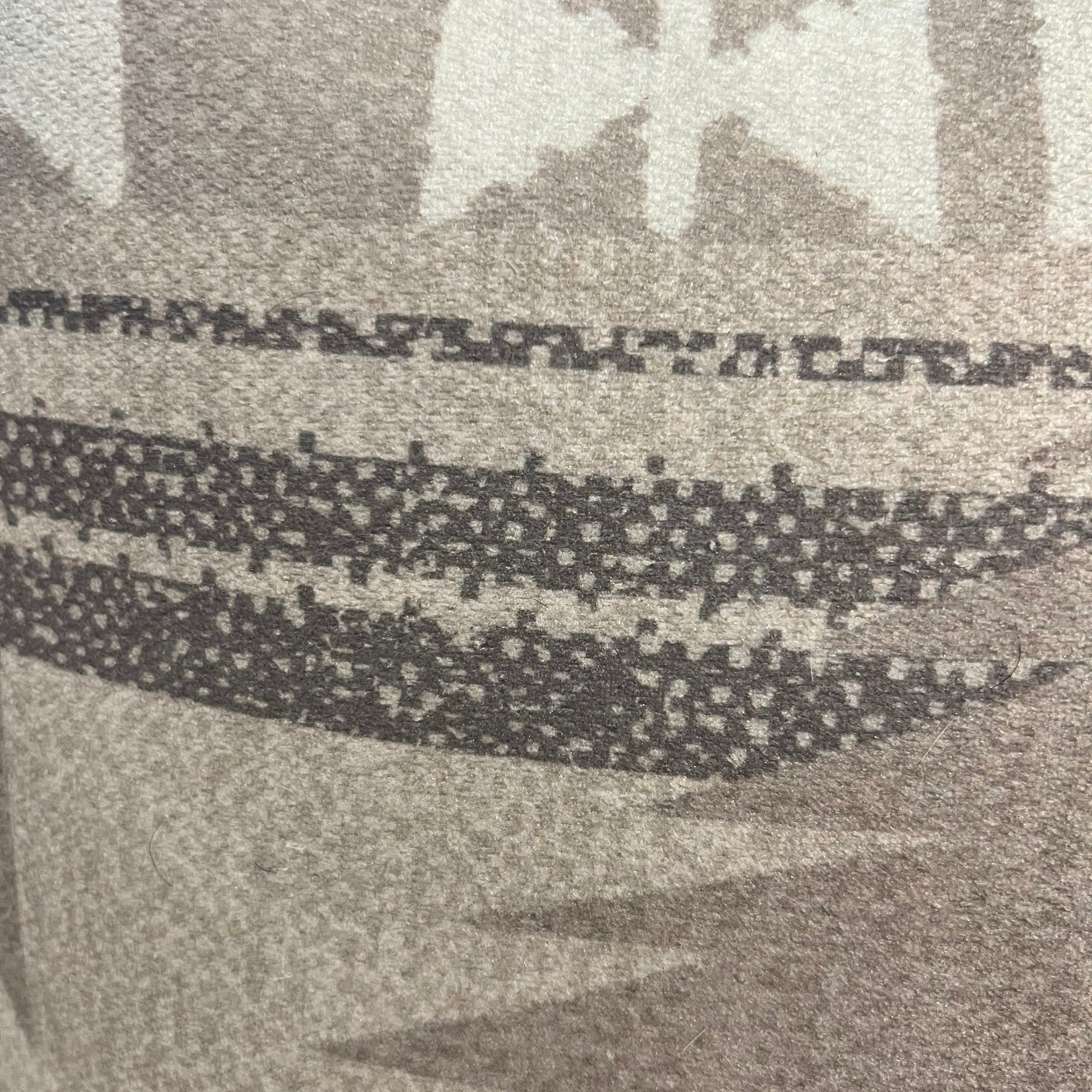 Close-up of a patterned fabric with geometric shapes in black and white.