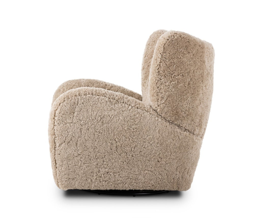 A modern, low-profile armchair upholstered in a textured, fuzzy bouclé fabric in a light beige color, shown from a side angle against a plain white background.