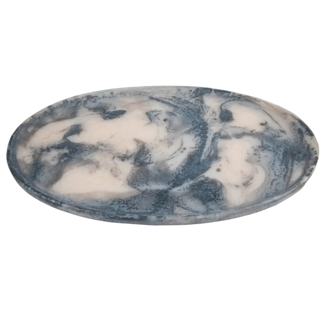 An oval marble tray with a swirling blue and white pattern, shown on a plain white background.