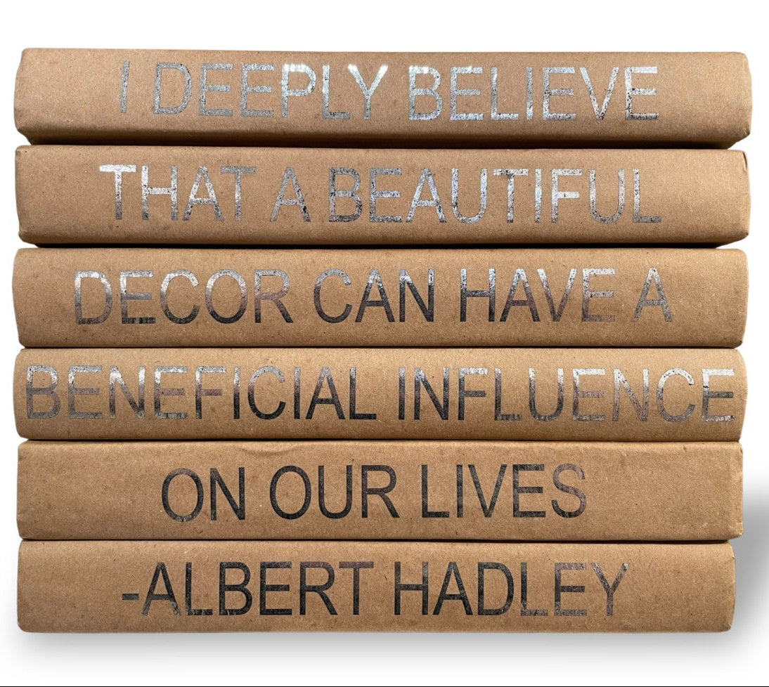 Stack of books with inspirational quote on a white background