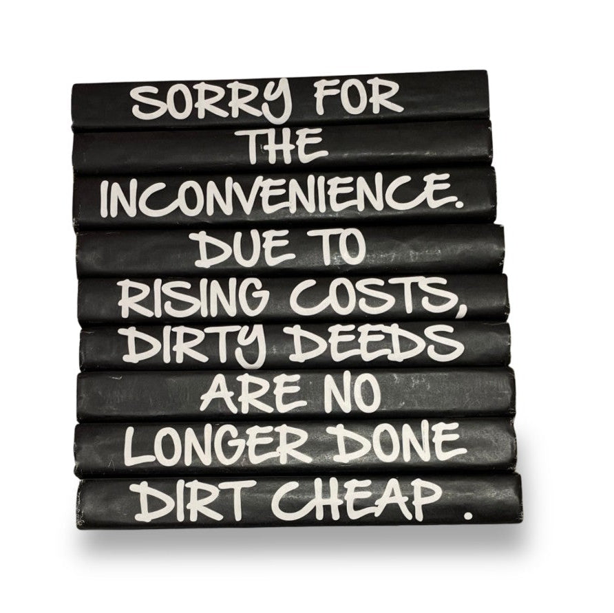 Stack of black chalk with white text on a white background