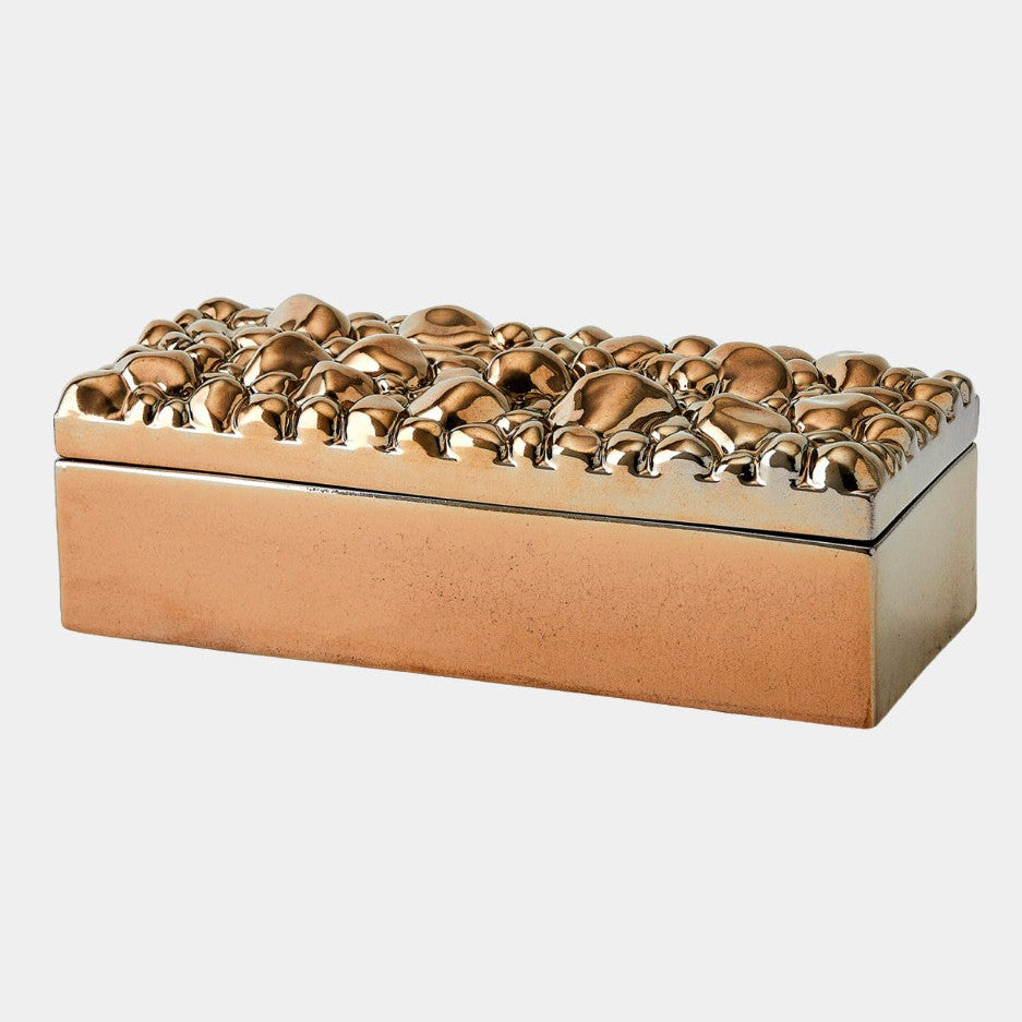 Decorative box with a textured gold top and beige base on a white background