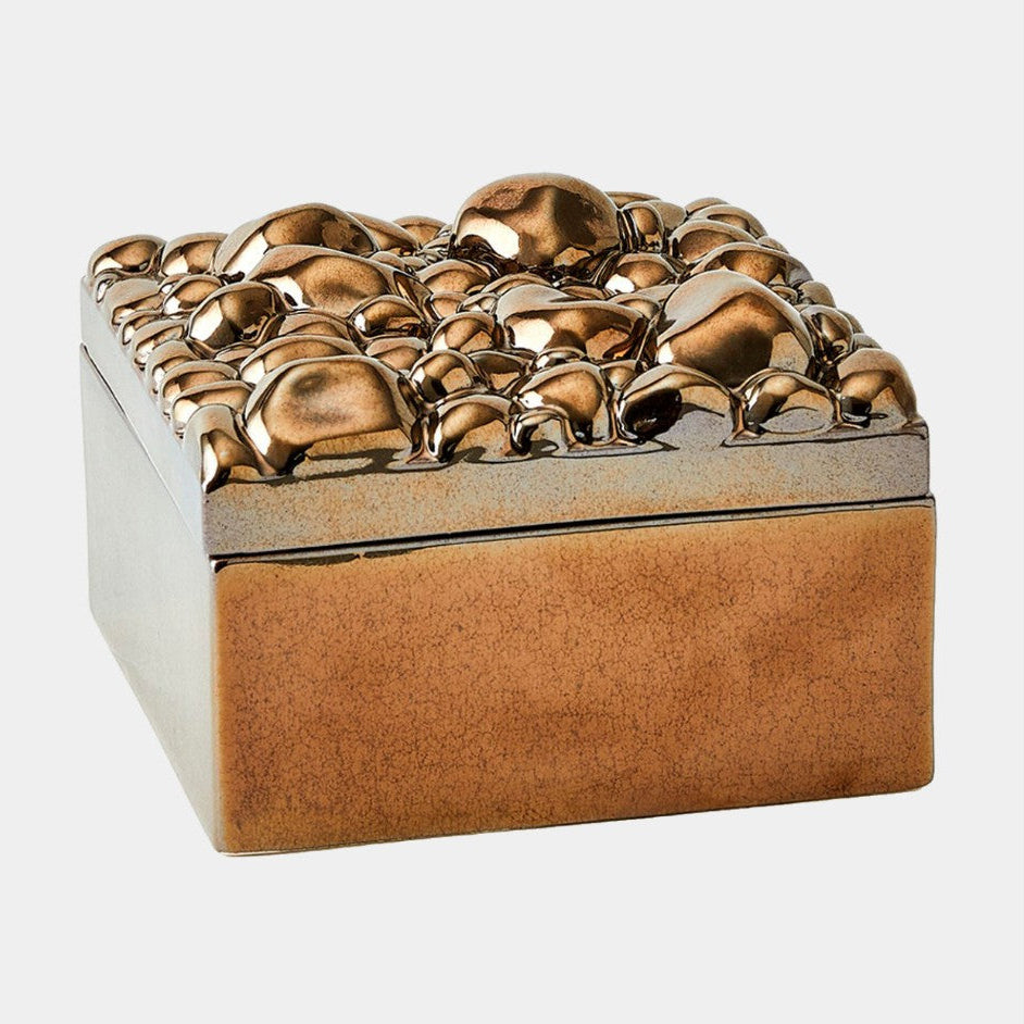 Decorative box with textured gold top and brown base on a white background