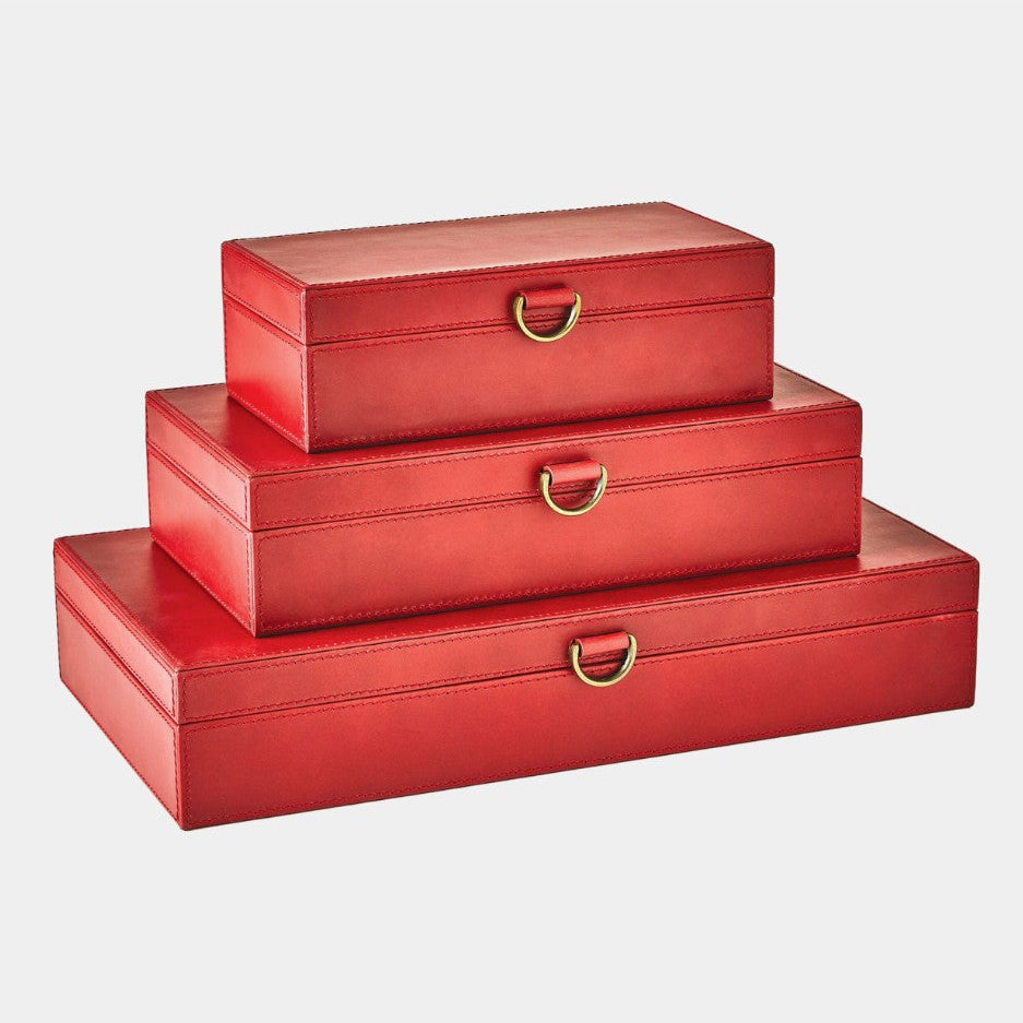 Set of three red jewelry boxes with gold handles on a light gray background