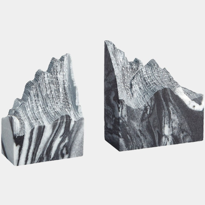 Two black and white marbled bookends on a light gray background