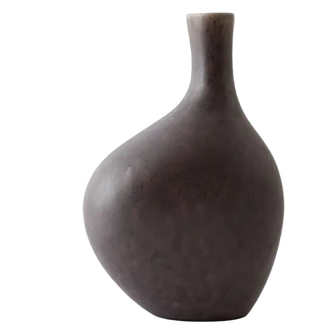 Dark brown ceramic vase on a light gray background