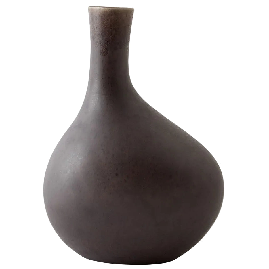 Dark brown ceramic vase on a light gray background
