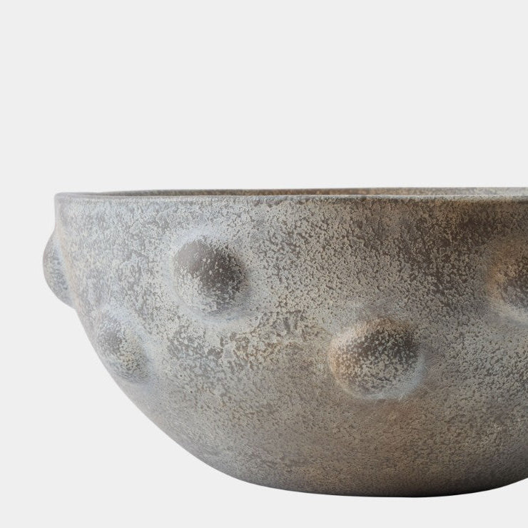 Textured ceramic bowl on a white background