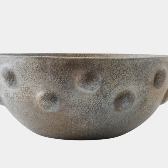 Textured ceramic bowl on a white background