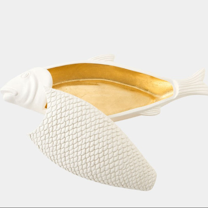 Fish-shaped dish with gold interior on a white background