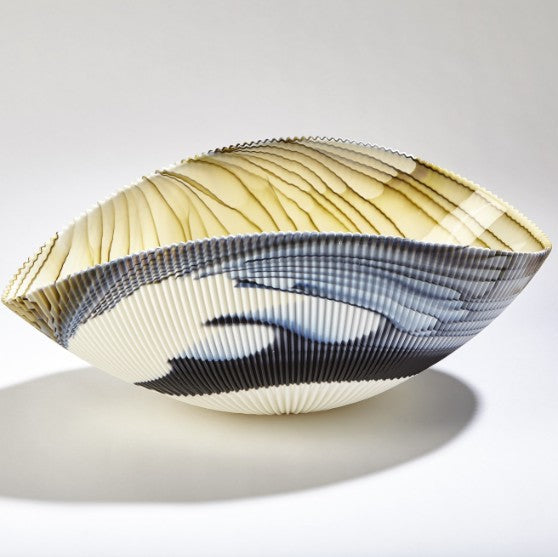 Decorative vase with pleated design on a white background