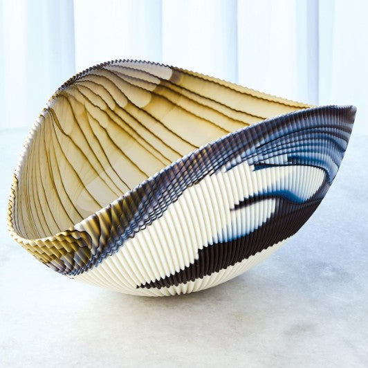 Decorative bowl with ribbed texture on a light background