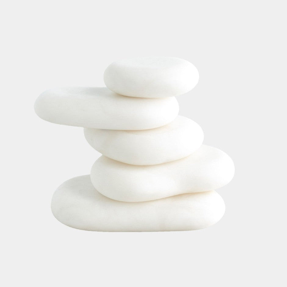 Stack of white stones on a white background