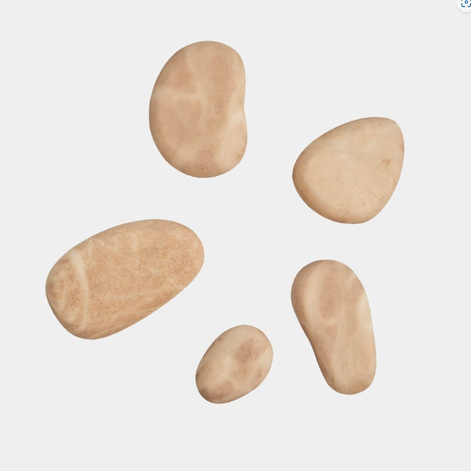 Five beige stones of varying sizes on a light gray background