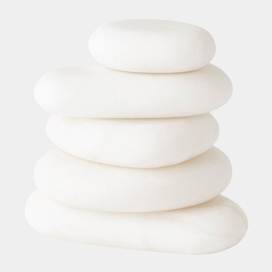 Stack of white stones on a light gray background