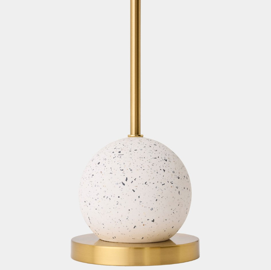 Decorative lamp with terrazzo-style base and gold accents on a white background