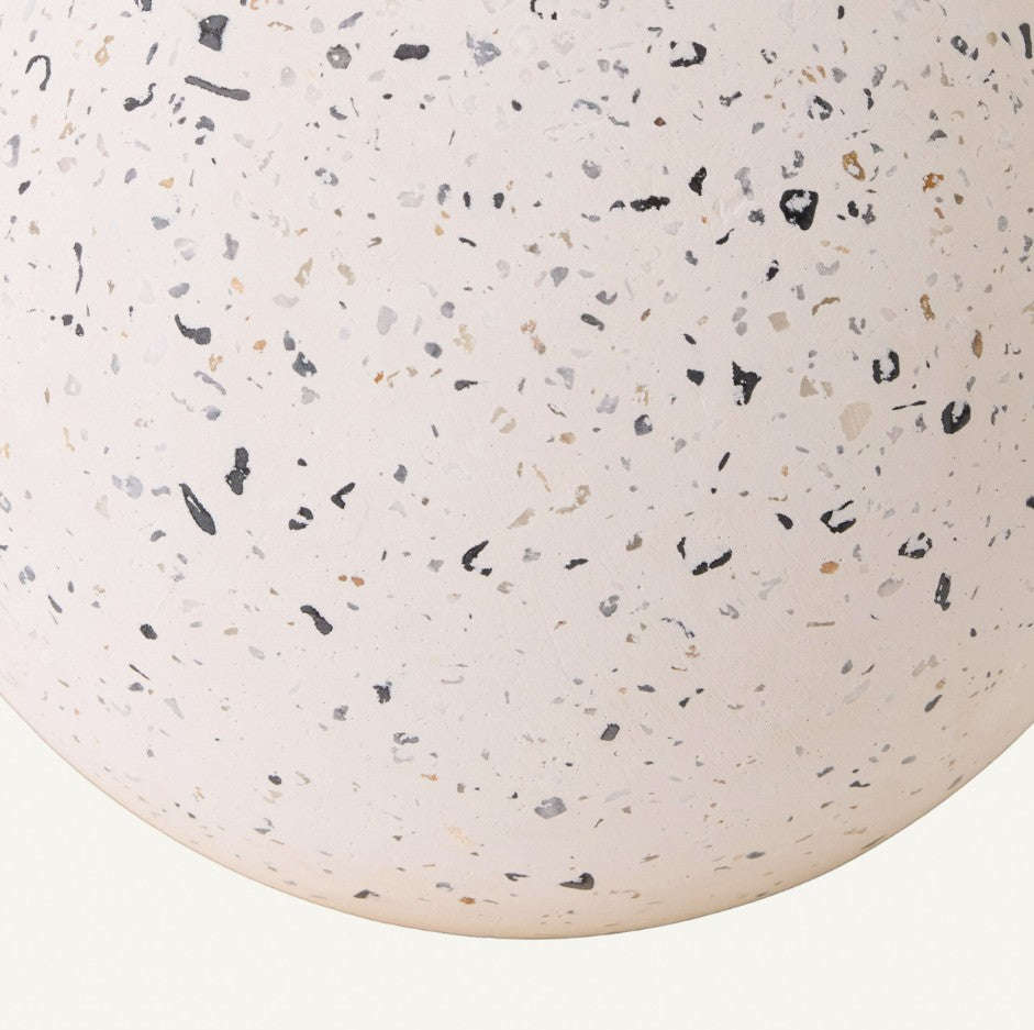 Close-up of a terrazzo-style surface with speckled pattern on a white background