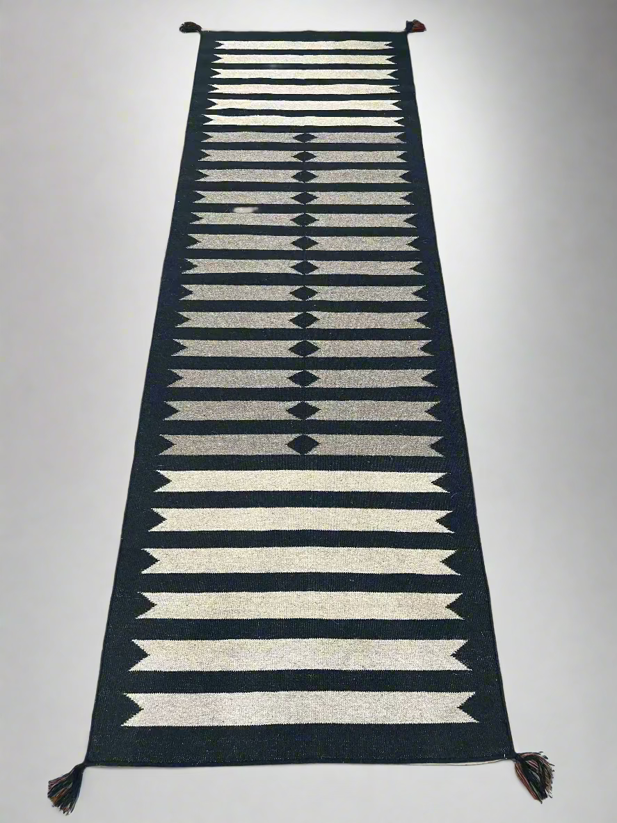 Woven runner with geometric pattern on a plain background