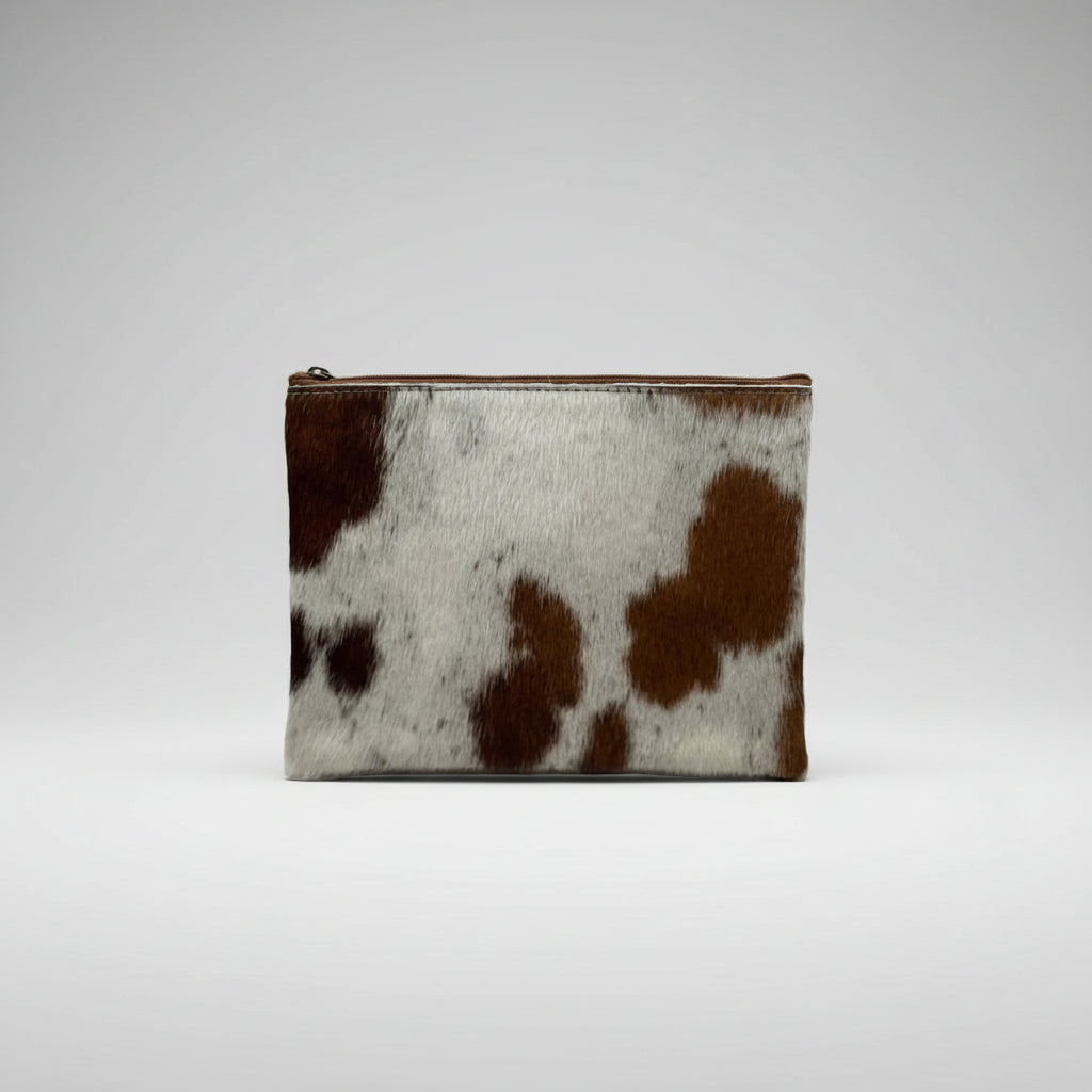 Pouch with cow print pattern on a white background