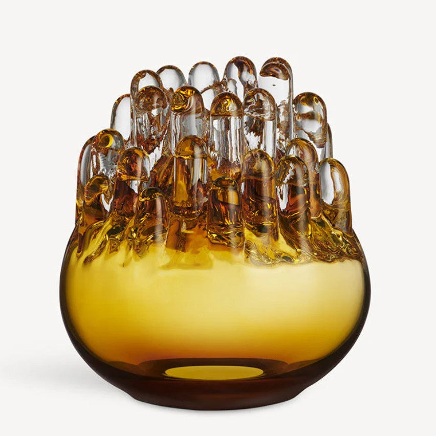 Glass vase with amber-colored glass and a white background