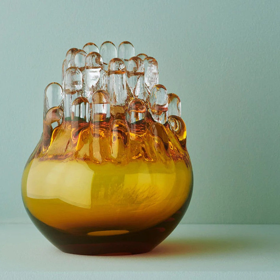 Glass vase with unique design on a light green background
