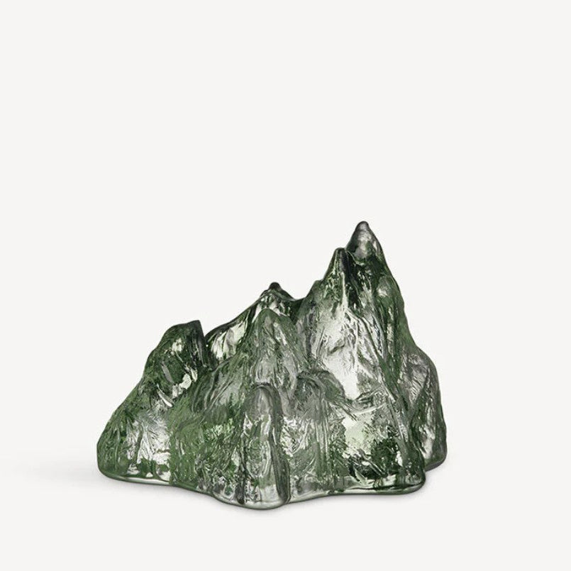 Green crystal mountain-like sculpture on a white background