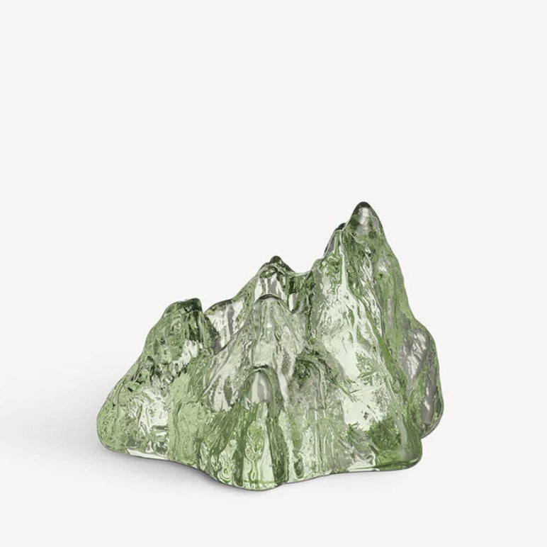 Green crystal mountain sculpture on a white background
