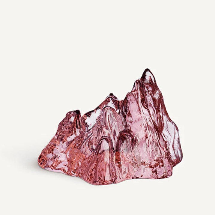 Pink crystal mountain sculpture on a white background