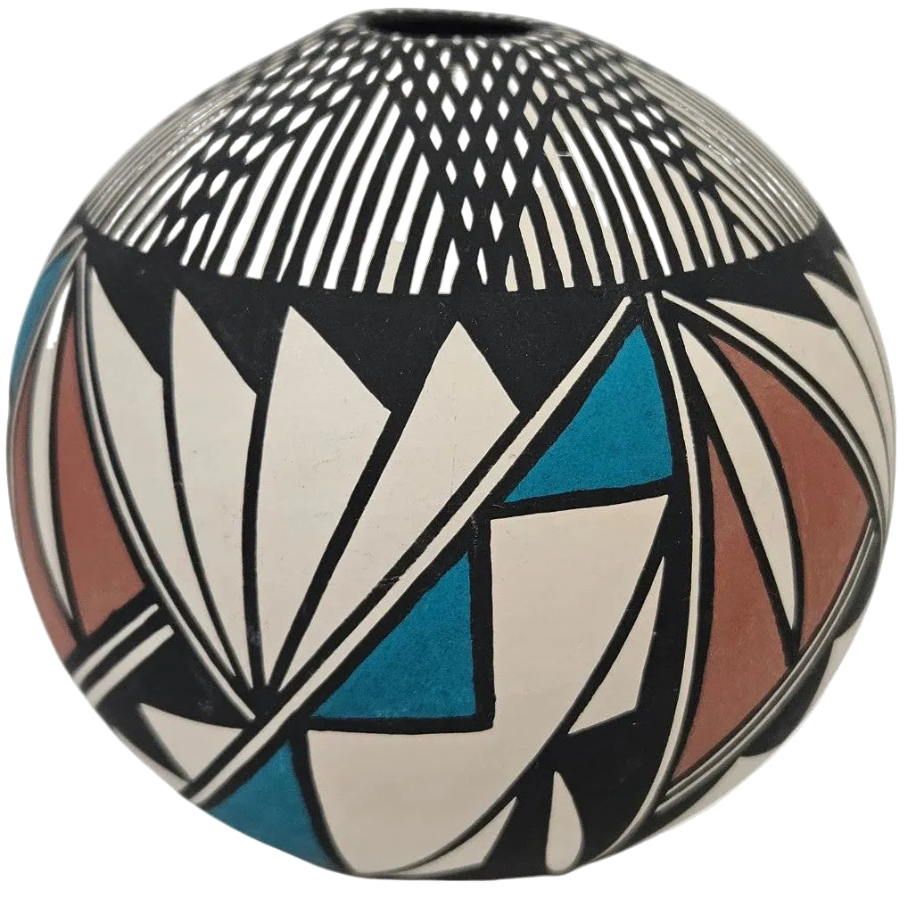 A spherical decorative ceramic vase with a geometric pattern in black, white, blue, and terracotta on a light gray background.