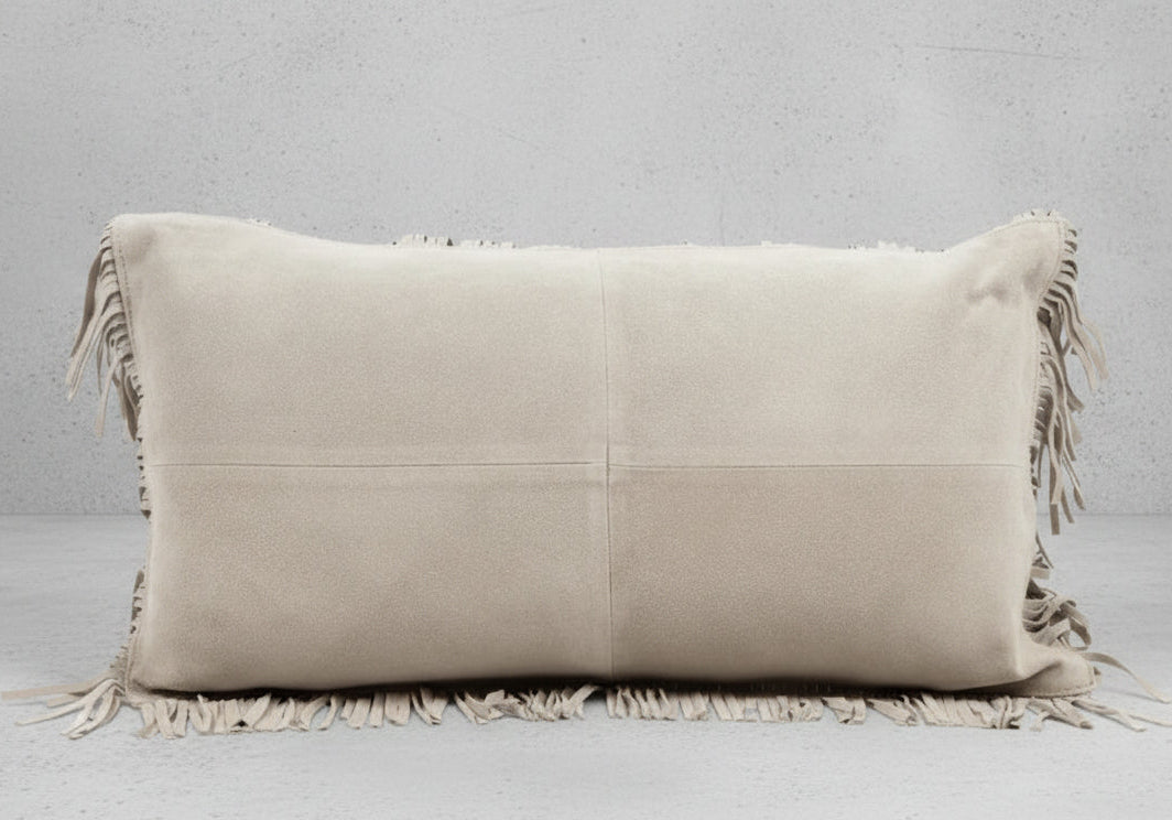 Beige pillow with fringes on a white background