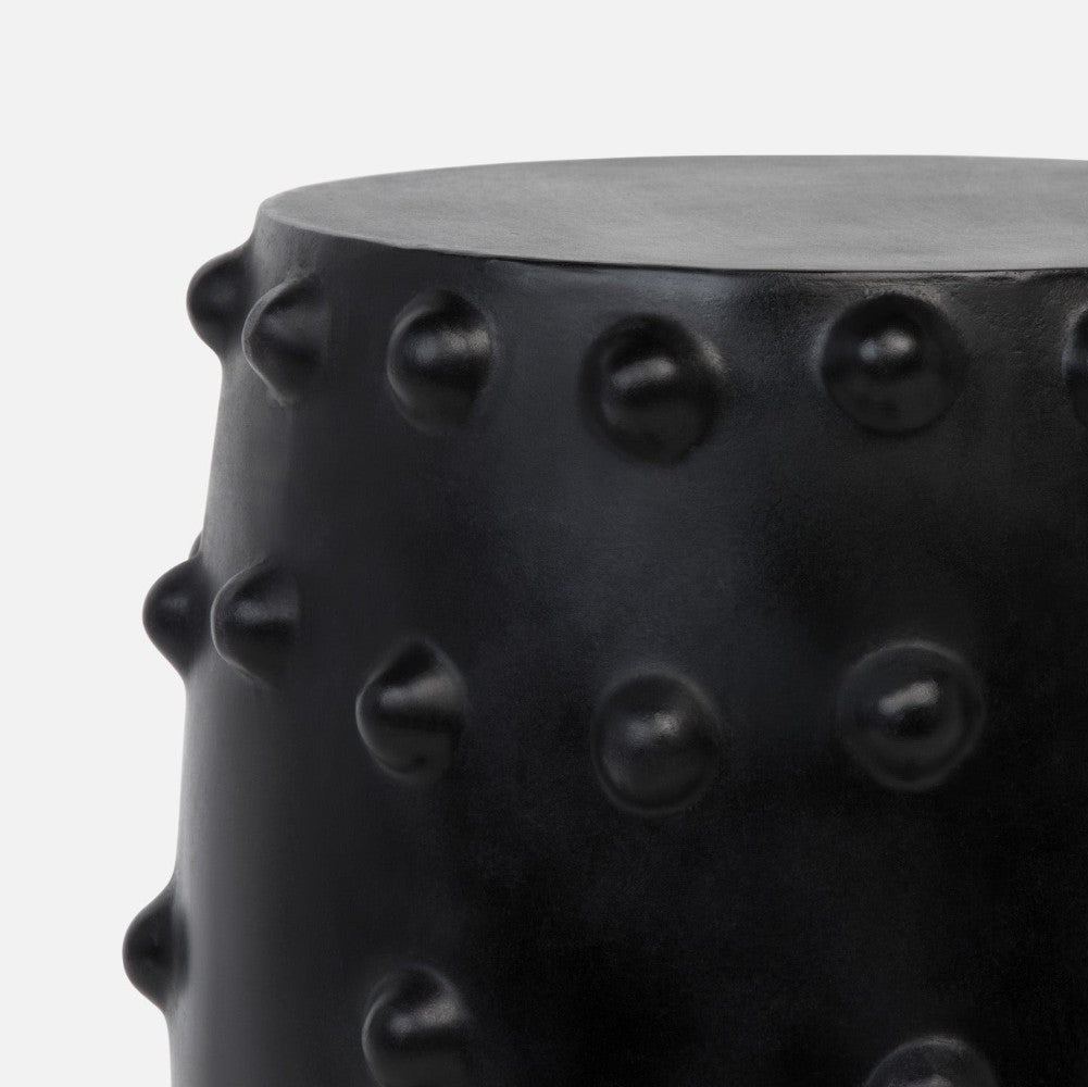 Black textured cylindrical object on a white background
