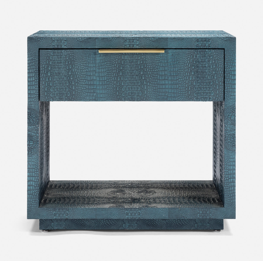 A modern two-drawer nightstand featuring a textured blue-green alligator skin finish, a single brass pull handle, and an open lower shelf, shown against a plain white background.