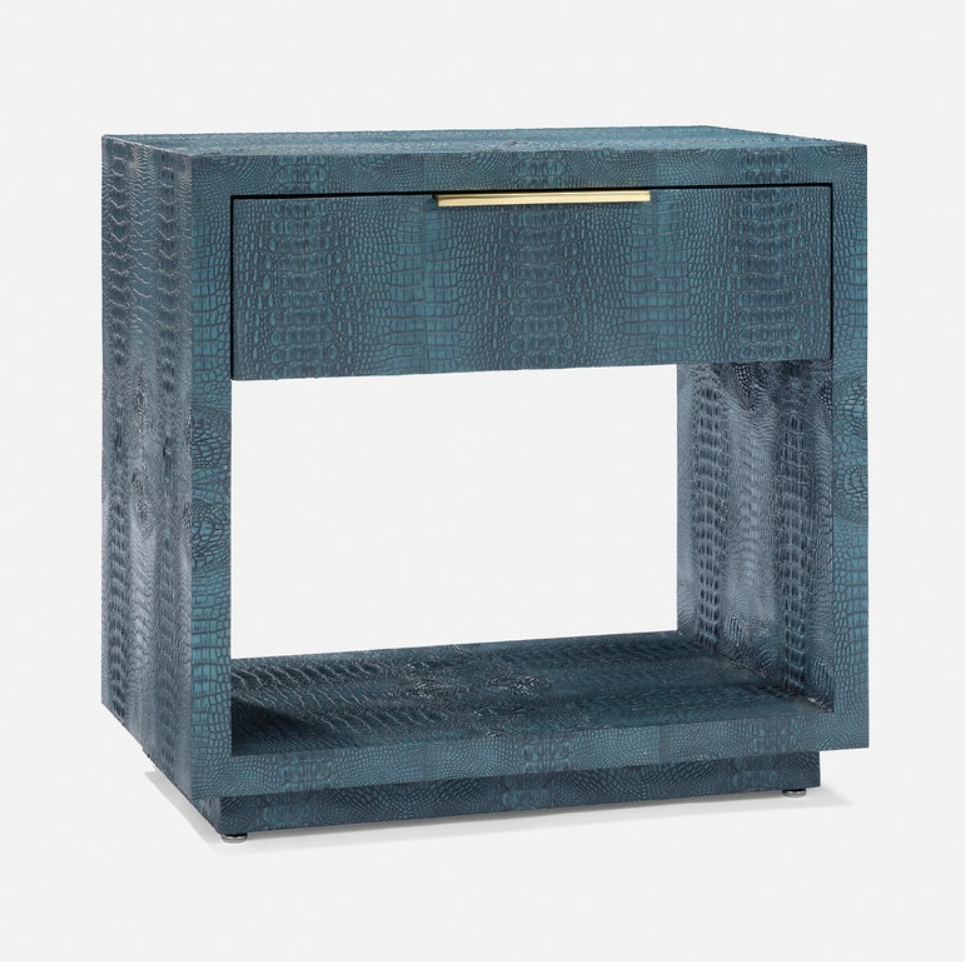 A modern open-front nightstand with a textured blue-green crocodile skin pattern, featuring a single drawer with a slim gold metal pull handle and an open lower shelf, shown on a light gray background.