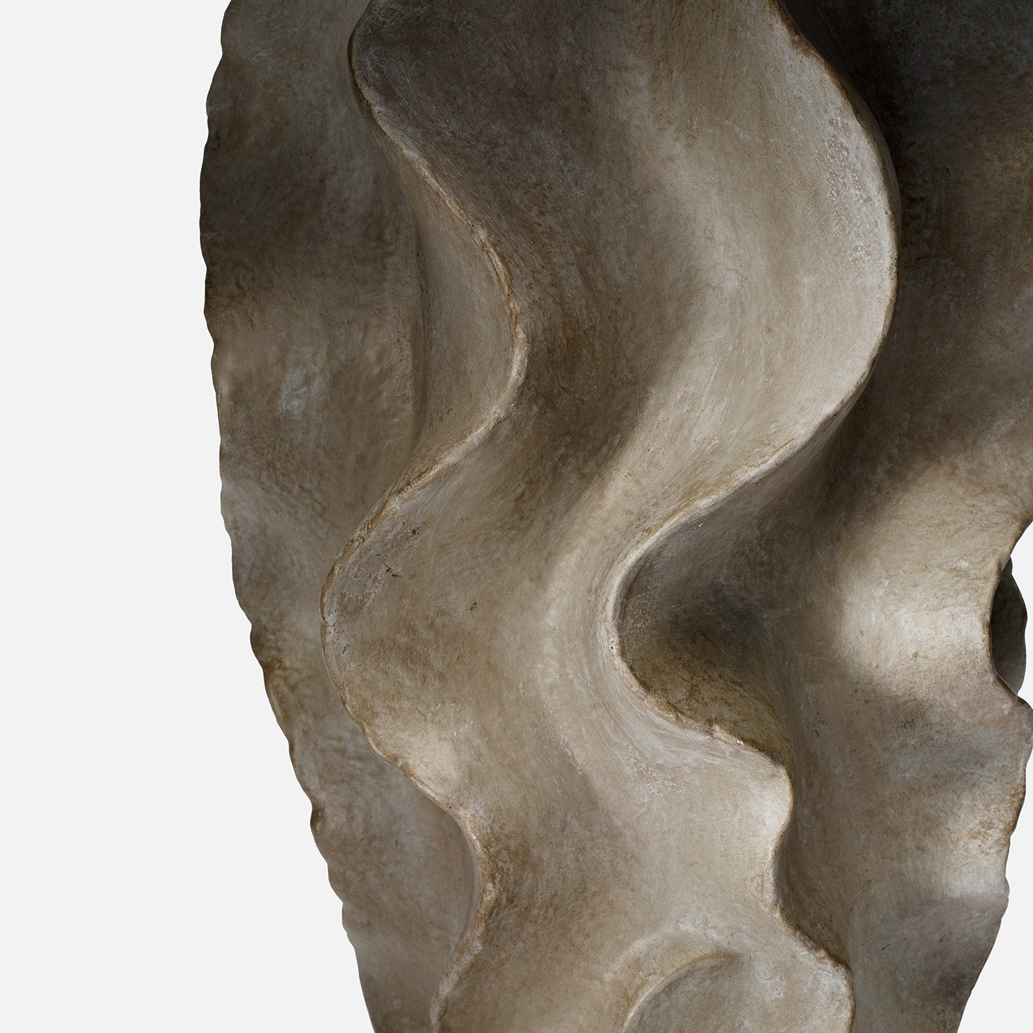 Close-up of a textured stone surface with wavy patterns on a white background