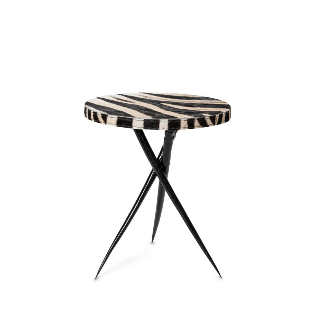 Small side table with zebra print top and black metal legs on a white background