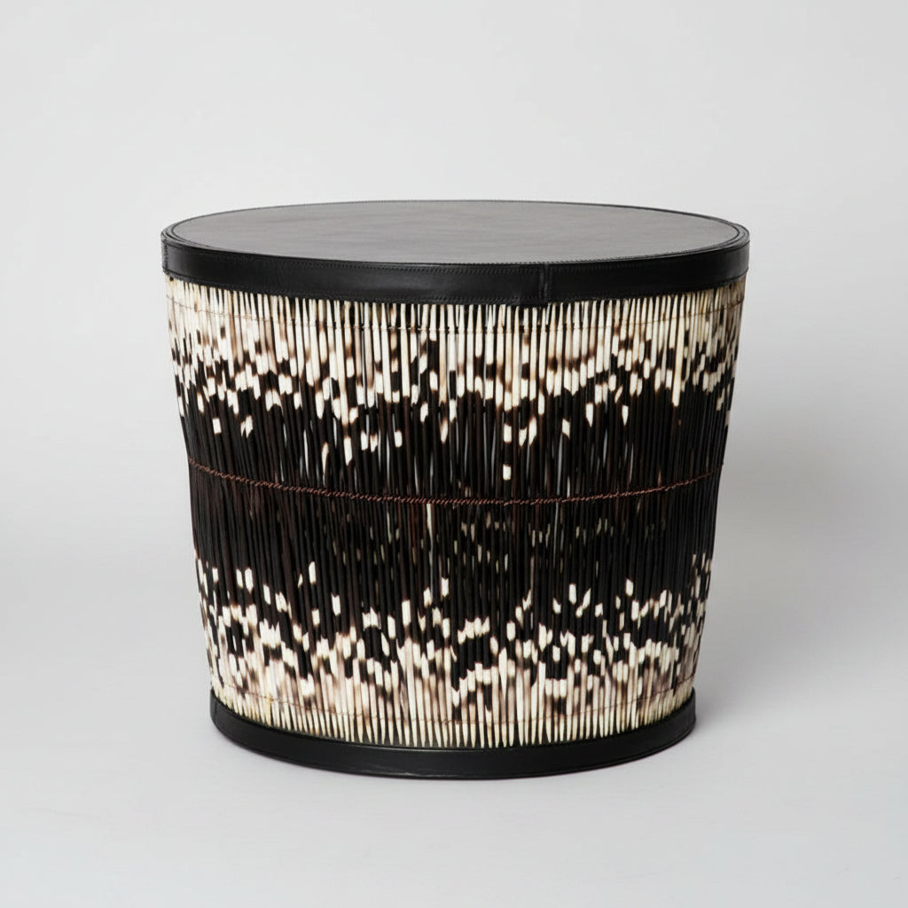 Decorative cylindrical table with a black and white pattern on a white background