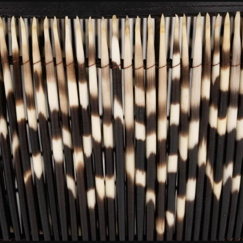 Close-up of a woven basket with black and white pattern