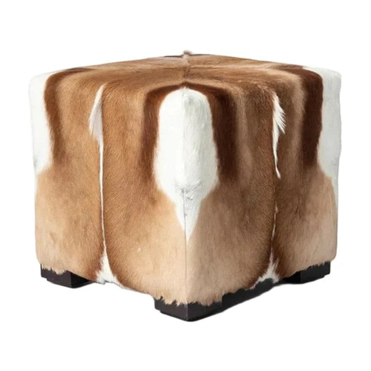 Cube-shaped ottoman with brown and white fur on a white background