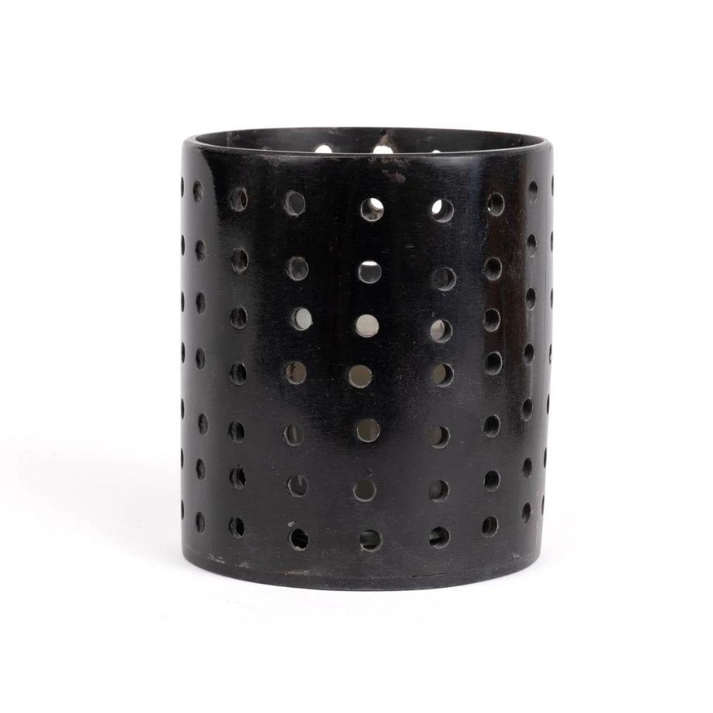 Black cylindrical horn votive with holes on a white background