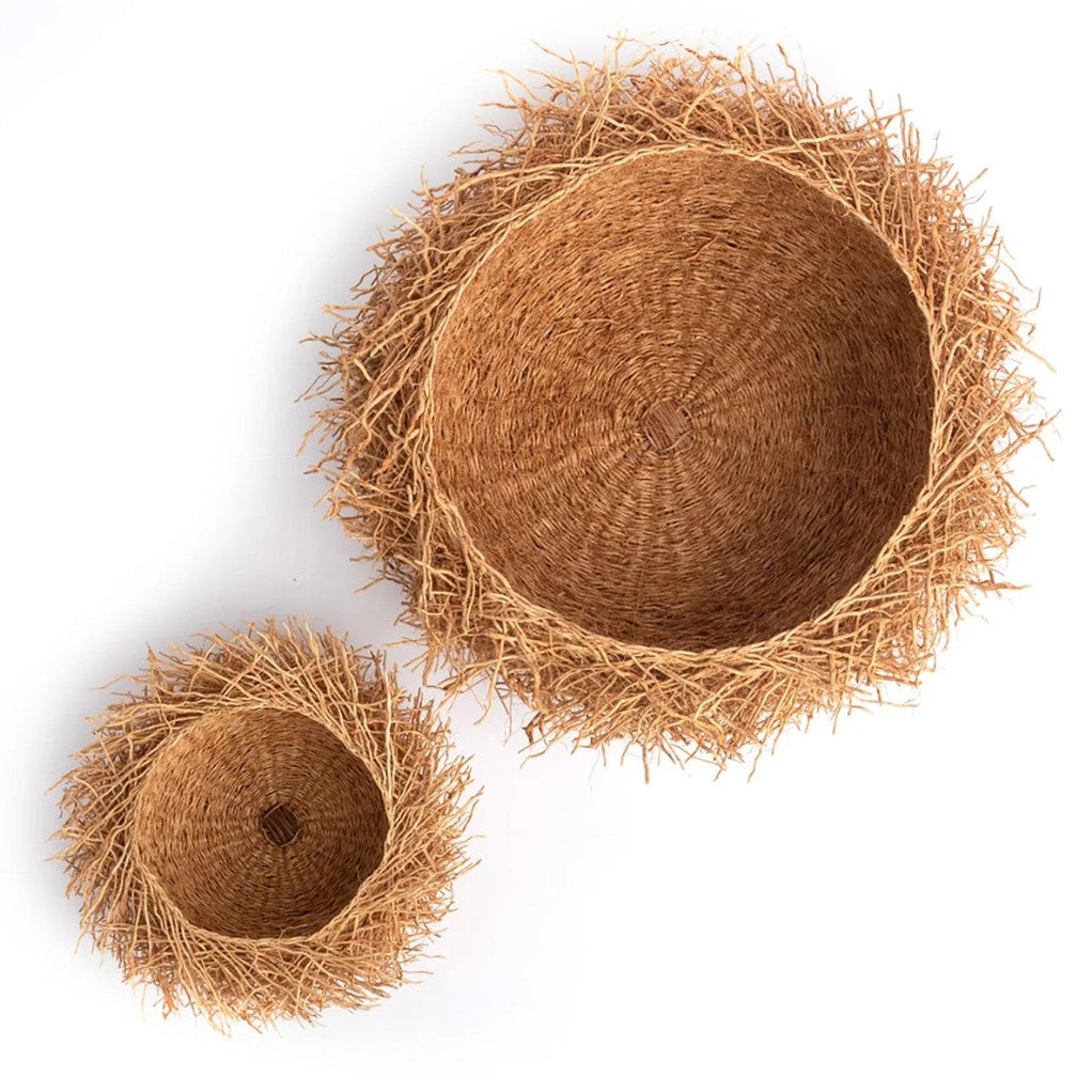 Two woven baskets made from natural fibers on a white background