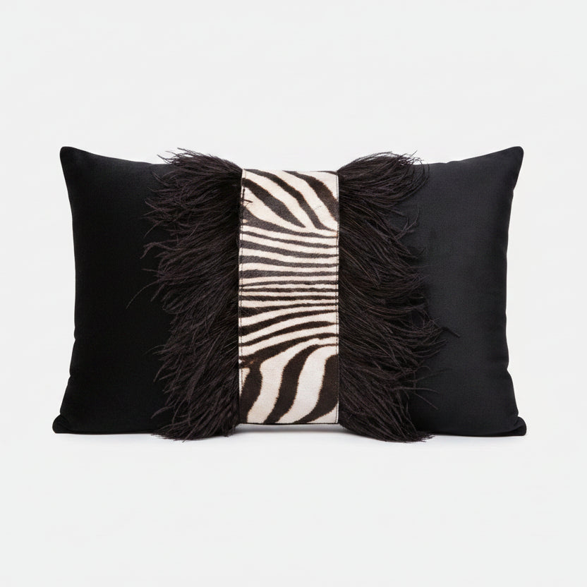 Decorative pillow with black feathers and zebra pattern on a white background