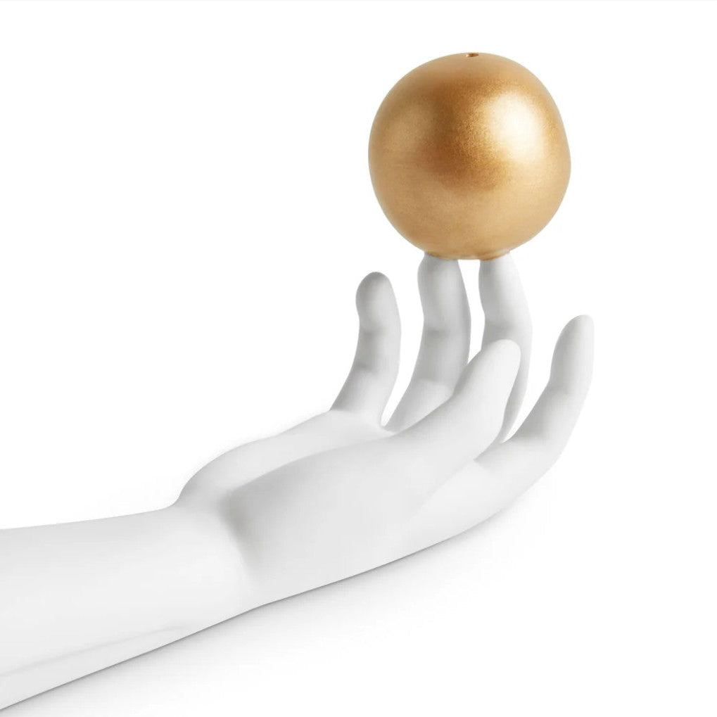 A white mannequin hand balancing a shiny metallic gold sphere on its fingertips against a plain white background.