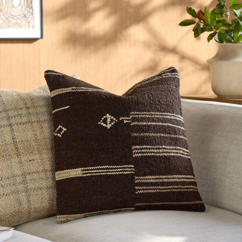 Decorative pillow with brown and beige pattern on a couch
